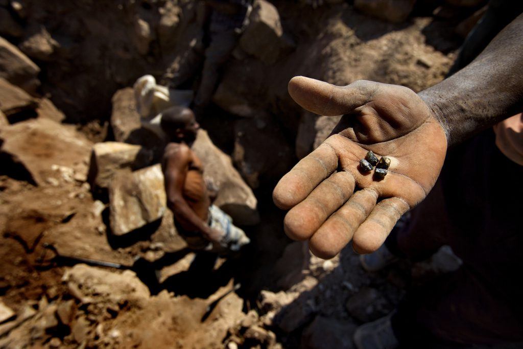 A diamond panner attempts to sell a diamond behind the backs of the military and police who demand all sales go through them. The Marange diamond fields in the east of Zimbabwe are under the direct control of the police and army, who use violence and intimidation to force local people to dig for diamonds on their behalf. The horrific conditions endured by the diggers appear to undermine the Kimberley Process, the international system meant to put a stop to the global trade in 'blood diamonds'.